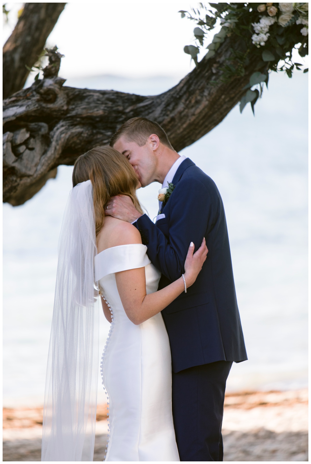 bride and groom kiss during baker's cay resort wedding ceremony